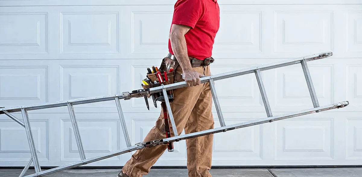 Garage door repair technician arriving with tools and ladder in Aurora, IL