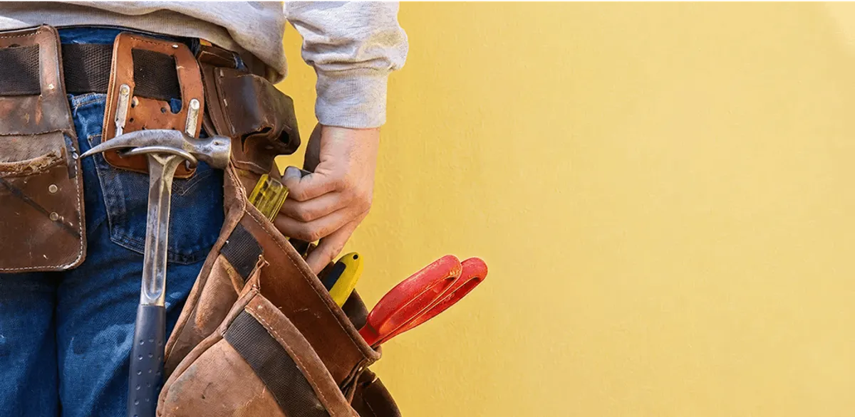 Handyman with tool belt ready for home repairs and maintenance in Aurora, IL